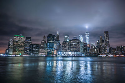 Illuminated buildings against sky at night