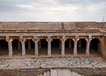 Old ruins of building against cloudy sky