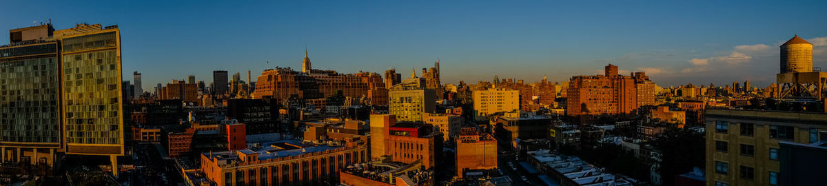 High angle view of buildings in city at sunset