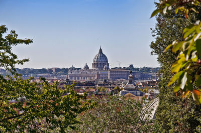 Mid distance view of st peters basilica against clear sky during sunny day