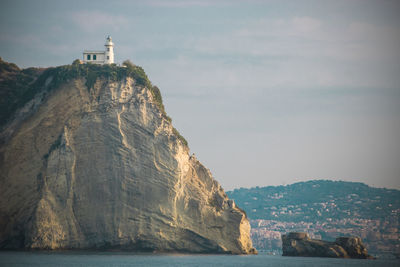 Rock formations by sea against sky