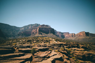 Rock formations on landscape against clear sky