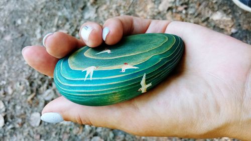 Close-up of person hand holding rock