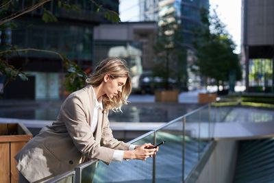Side view of woman using mobile phone