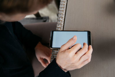 Midsection of man using mobile phone