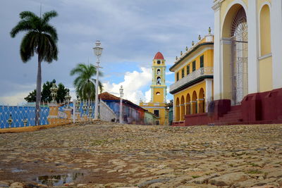 Palm trees and church against sky