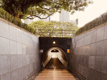 Footpath amidst buildings in city