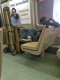 Portrait of man sitting on seat in bus