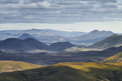 Overcast sky over green hills and mountains