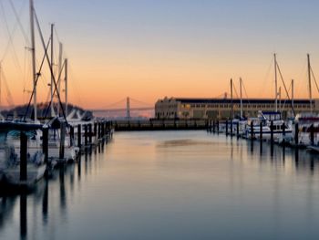 Sailboats in marina at sunset