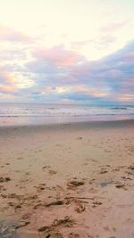 Scenic view of beach against sky during sunset