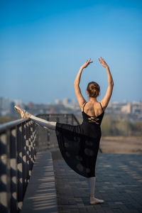 Rear view of woman standing outdoors