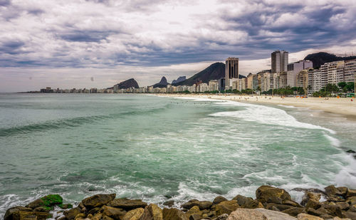 Scenic view of sea and buildings against sky