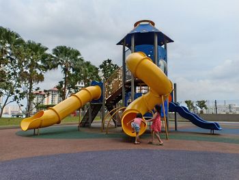 Lifeguard hut on playground against sky in park