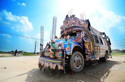 Decorated semi-truck on roadside against sky