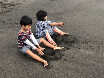 High angle view of friends on sand