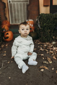 Adorable toddler boy dressed up as mummy on halloween trick-or-treat