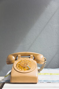 Rotary telephone on table