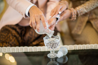 Cropped image of man holding water