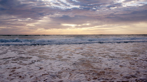 Scenic view of beach against sky during sunset