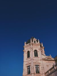 Low angle view of building against clear blue sky