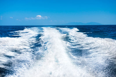Scenic view of sea against blue sky