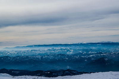 Scenic view of snowcapped mountains against sky