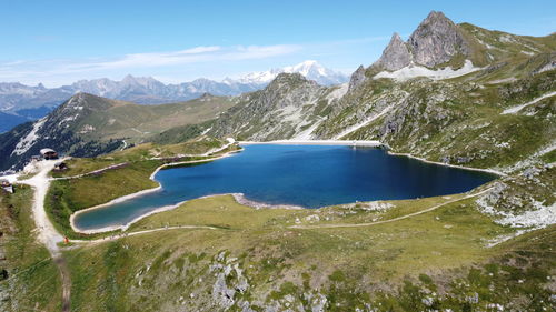 Scenic view of lake and mountains against sky