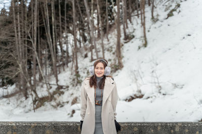 Portrait of woman standing in snow