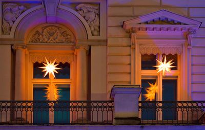 Illuminated lamp by building at night