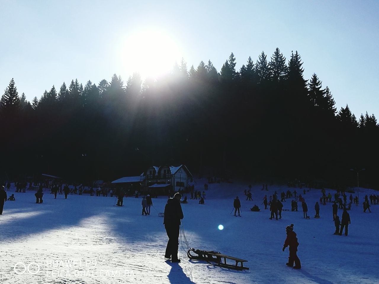 PEOPLE WALKING ON SNOW COVERED LANDSCAPE AGAINST SKY