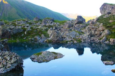 Scenic view of lake and mountains against sky