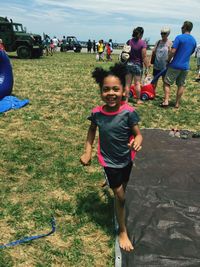 Little girl playing with arms raised