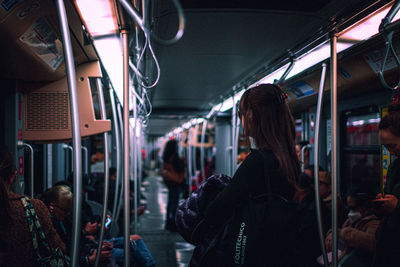 Rear view of people traveling in train