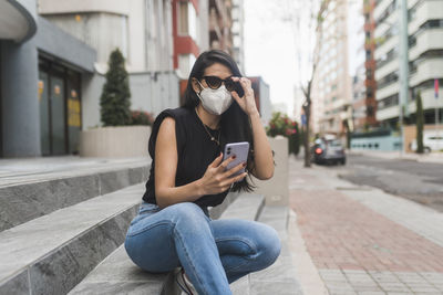 Man using mobile phone in city