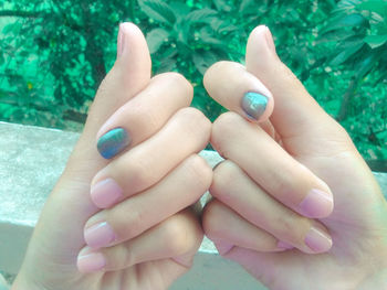 Cropped hands of woman with painted nails