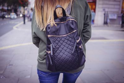 Rear view of woman walking on street