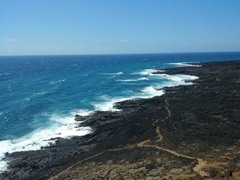 Scenic view of sea against clear blue sky