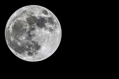 Low angle view of moon against black background