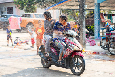 People riding motorcycle on street in city