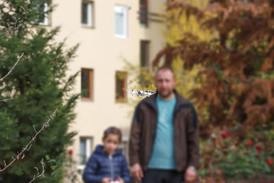 Portrait of man standing against plants