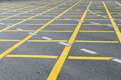 High angle view of yellow arrow symbol on road