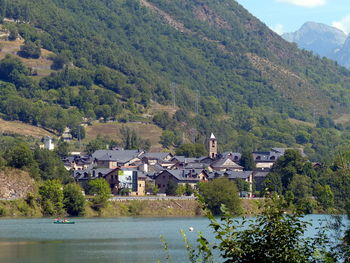 Scenic view of houses and buildings against mountains