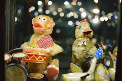 Close-up of toys seen through glass