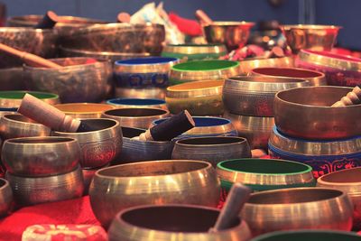 Close-up of various singing bowls on table