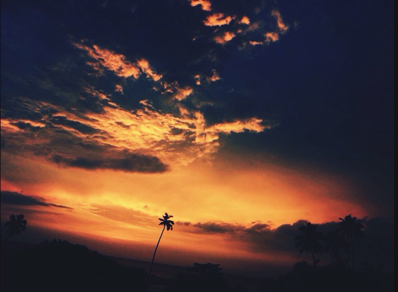 sunset, silhouette, sky, orange color, cloud - sky, low angle view, beauty in nature, scenics, dramatic sky, tranquility, cloudy, cloud, tranquil scene, nature, idyllic, dusk, outdoors, moody sky, no people, atmospheric mood