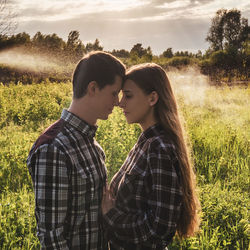 Young couple standing on field