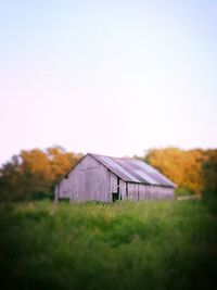 Tilt-shift image of built structure on field against clear sky