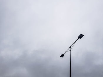 Low angle view of street light against sky