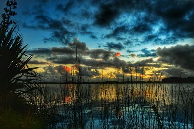 Scenic view of lake against cloudy sky